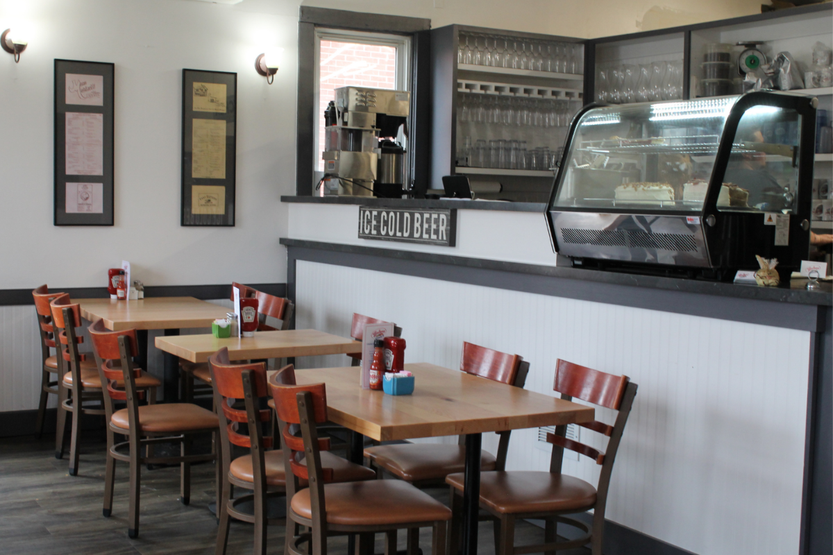 Interior of Galena Diner showing wooden tables, orange chairs, and a "Ice Cold Beer" sign in Galena, Ohio.