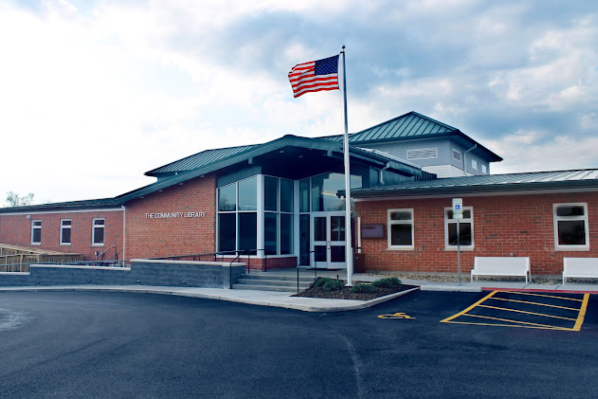 Exterior of the Community Library in Sunbury, Ohio, featuring a modern brick building and an American flag.