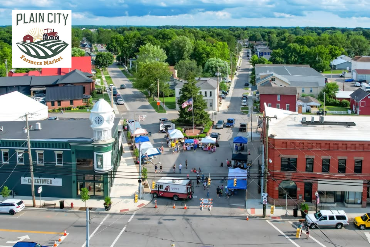 Aerial view of downtown Plain City Farmers Market with vendors and tents set up on the street.